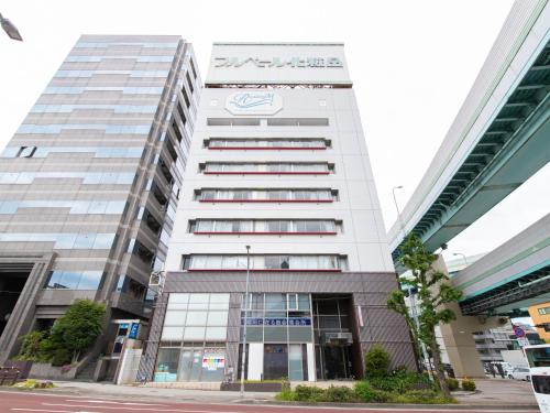 a tall white building with a sign on it at Reality Hakata 2 in Fukuoka