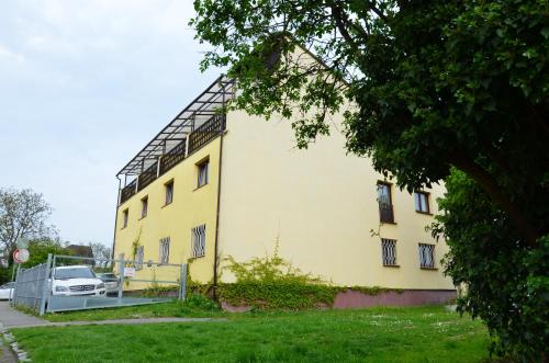 a yellow building with a car parked next to it at Hotel Wolf in Prague