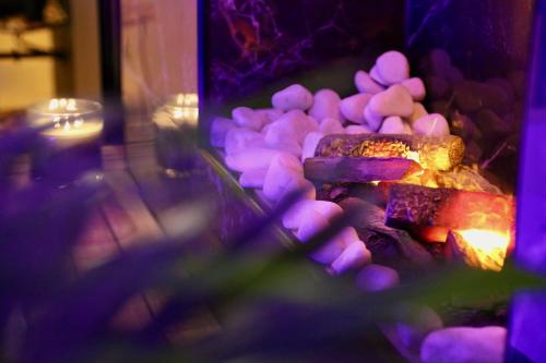 a pile of food is cooking in a fireplace at love room gold - les delices rooms in Angers