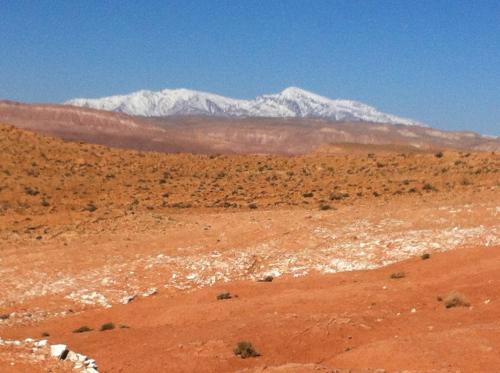 a view of a desert with a snow covered mountain at Kasbah Titrit & Spa in Aït Ben Haddou