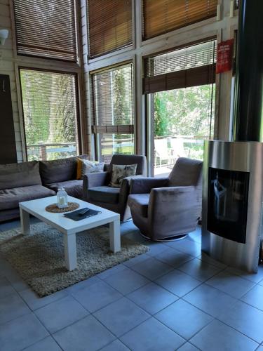 a living room with a couch and a coffee table at Kiurun Villas in Imatra