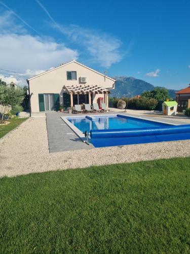 a house with a swimming pool in the yard at Villa MirIva in Katuni
