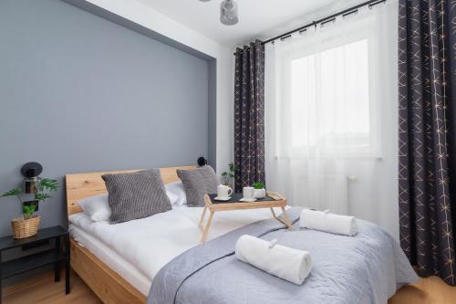 a bedroom with two beds and a window at Cozy Apartment with Balcony Chmieleniec by Renters in Krakow