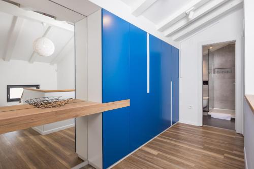 a blue sliding door in a kitchen with a hallway at Villa Lomida Opatija in Opatija