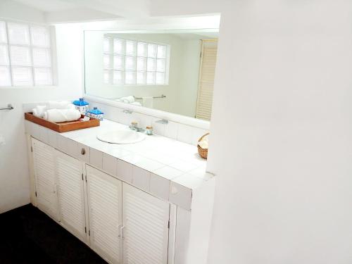 a white bathroom with a sink and a mirror at Suite 1-A Monasterio Garden House Welcome to San Angel in Mexico City