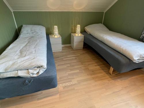 um quarto com duas camas e duas mesas de cabeceira em Holiday home Huglo II em Nordhuglo