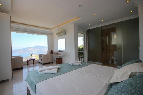 a bedroom with two beds and a view of the ocean at Villa MK in Kalkan