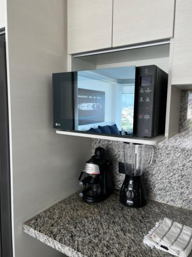a kitchen counter with a blender and a mirror at Suite Exclusiva frente al mar Hotel Poseidón Manta in Manta