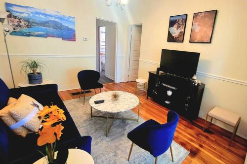 a living room with a couch and chairs and a table at Chateau de Woodlawn - Peaceful 3 bedroom apartment. in Chicago