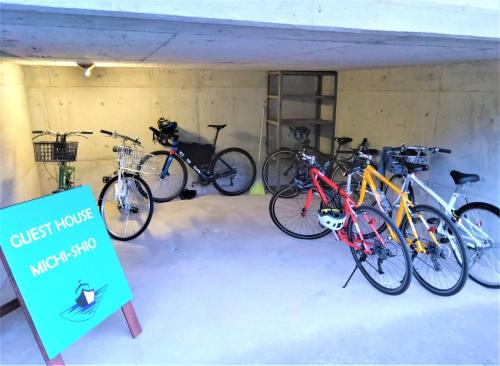 a group of bikes parked in a garage at ゲストハウスみちしお in Hikino