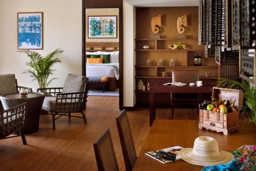 a living room with a table and chairs at Lapita, Dubai Parks and Resorts, Autograph Collection in Dubai