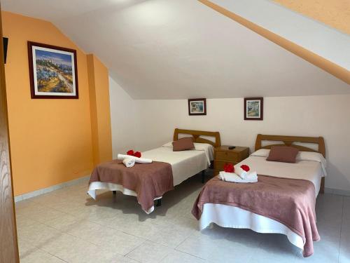 a bedroom with two beds with towels on them at Playa Y Cañas in Noja