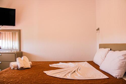 a room with a bed with two towels on it at Theano Studios in Paralia Sikias