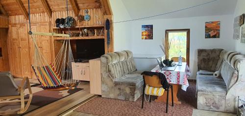 a living room with two chairs and a table at La Unchesu in Gorgova