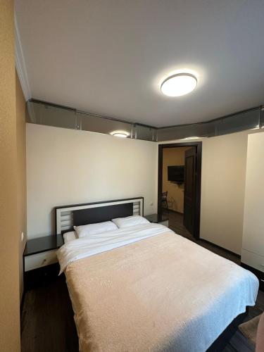 a bedroom with a large white bed in it at Pirosmani Mini Hotel in Batumi