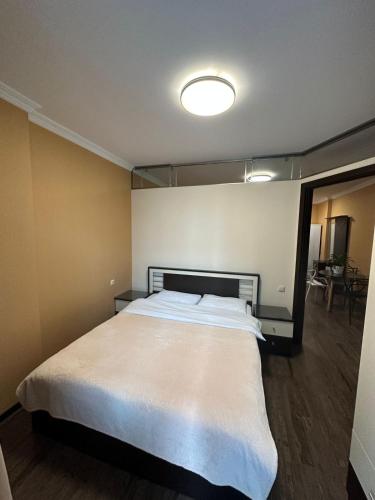 a bedroom with a large white bed in it at Pirosmani Mini Hotel in Batumi