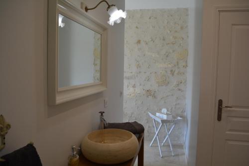 a room with a window and a wooden bowl on the wall at la cabanne in Saint-Martin-Lacaussade
