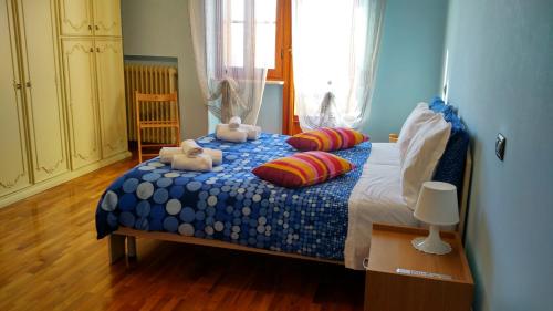 a bedroom with a bed with two stuffed animals on it at B&B L'Aquila in LʼAquila