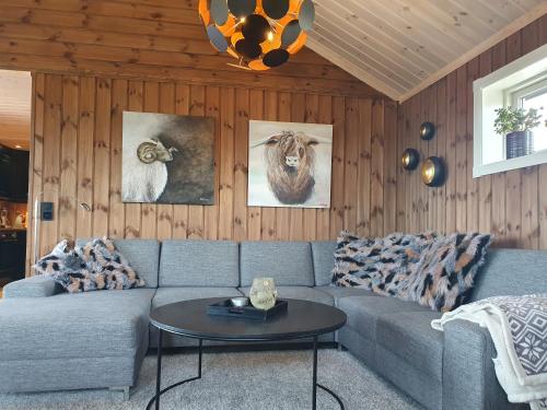 a living room with a couch and a table at Wonderful cabin with amazing mountain - view in Lifjell