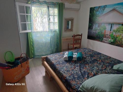 a bedroom with a bed with a teddy bear on it at RÊV BOR D'MER in Étang-Salé les Bains