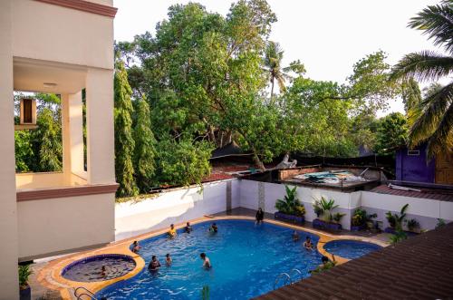 a group of people in a swimming pool on a building at La Oasis by Meraden ,Goa in Anjuna