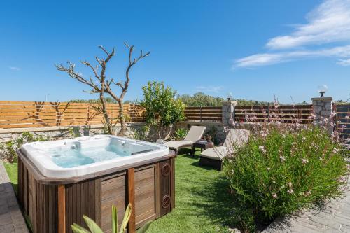 a jacuzzi tub in the yard of a garden at Casa Bonita Afandou in Rhodes Town