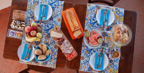a wooden table with plates of food on it at Orlando Bayview in Balestrate