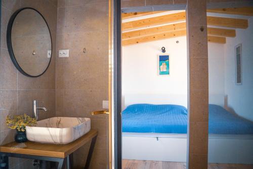 a bathroom with a sink and a bunk bed at KUĆA OD SOLI in Sveti Jakov