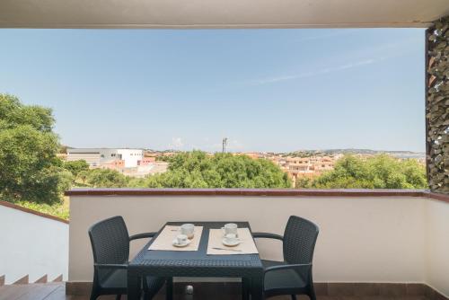 a table and chairs on a balcony with a view at La Gioia in Palau