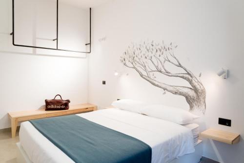 a bedroom with a bed with a drawing on the wall at BOTTASSO17 Guest House a due passi dal mare in Terracina