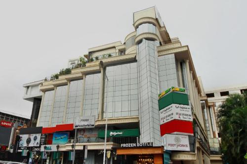 a large building with a lot of signs in front of it at Monarch Brigade Road in Bengaluru