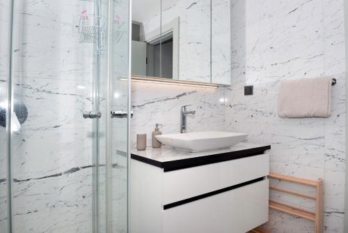 a bathroom with a sink and a glass shower at Queen Residence By A in Istanbul