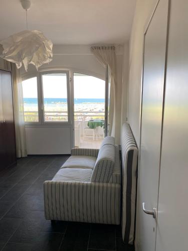 a living room with a couch and a view of the ocean at Residence Le Terrazze Sul Mare in San Mauro a Mare
