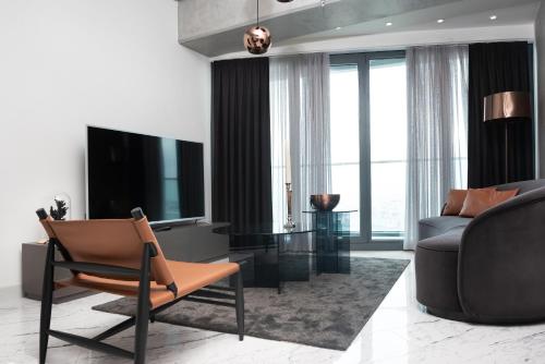 a living room with a television and a couch at Queen Residence By A in Istanbul