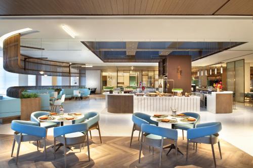 a rendering of a restaurant with tables and chairs at Holiday Inn Express Beijing Badaling by IHG in Yanqing