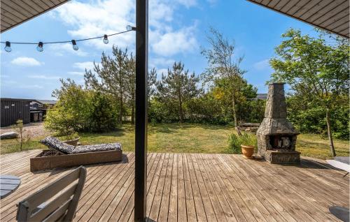 a patio with a fireplace on a wooden deck at Amazing Home In Tarm With Kitchen in Tarm