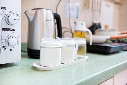 a counter with four containers of milk on a counter top at Student Accommodation - Lockhart Road 137 in Hong Kong