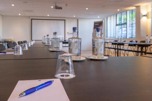 a pen sitting on top of a table in a room at Fletcher Hotel Jan van Scorel in Schoorl