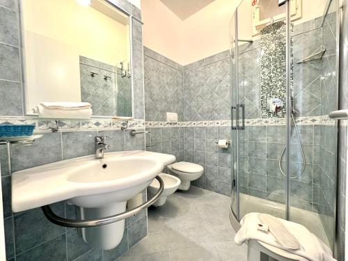 a bathroom with a sink and a toilet and a shower at Hotel Marconi in Sperlonga