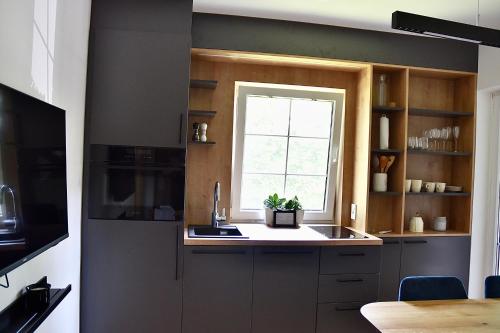 a kitchen with a sink and a window at Olimian Oasis Village Lipa 107 in Podčetrtek
