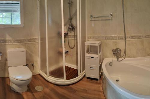 y baño con ducha, aseo y bañera. en Villa Altea Original Industrial Vistas Panorámicas, en Altea