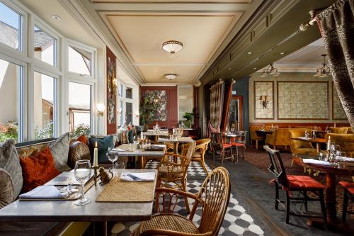 a restaurant with tables and chairs in a room at The Bath Hotel in Lynmouth