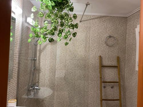 a bathroom with a shower and a chandelier at Garden View Apartment in Athens
