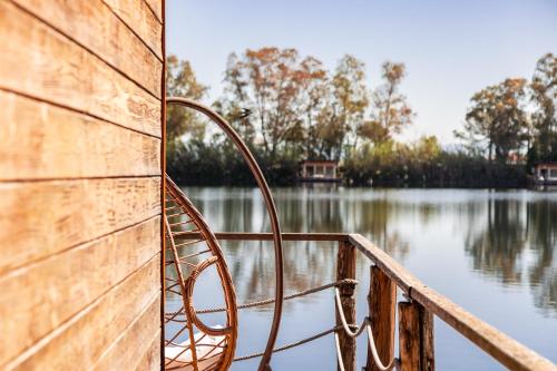 a metal bench sitting on the side of a boat at Plana Resort & SPA in Castel Volturno