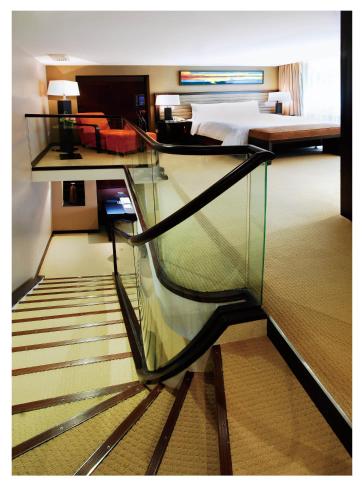 a staircase in a hotel room with a bed at Shenzhen Sunshine Hotel, Luohu in Shenzhen