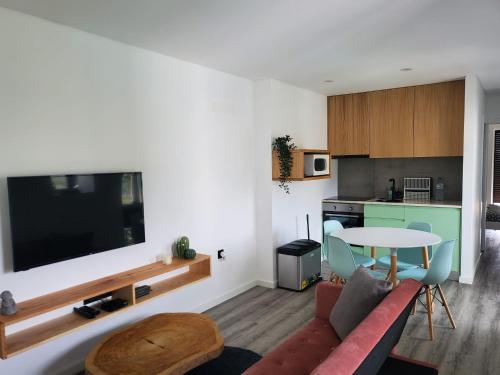 a living room with a couch and a table at Douro Mesio Guest House in Resende