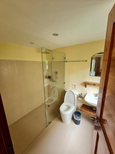 a bathroom with a toilet and a sink at Boracay Amor Apartment in Boracay