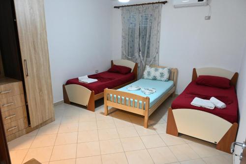 a small room with two beds and a couch at Iris apartaments in Sakës