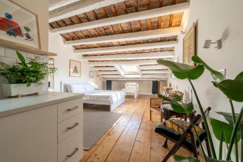 a kitchen and living room with wooden ceilings and plants at Apartments & Rooms Carera 6 in Rovinj