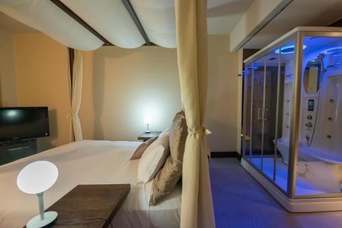 a bedroom with a bed and a sliding glass door at Main Palace Hotel in Roccalumera
